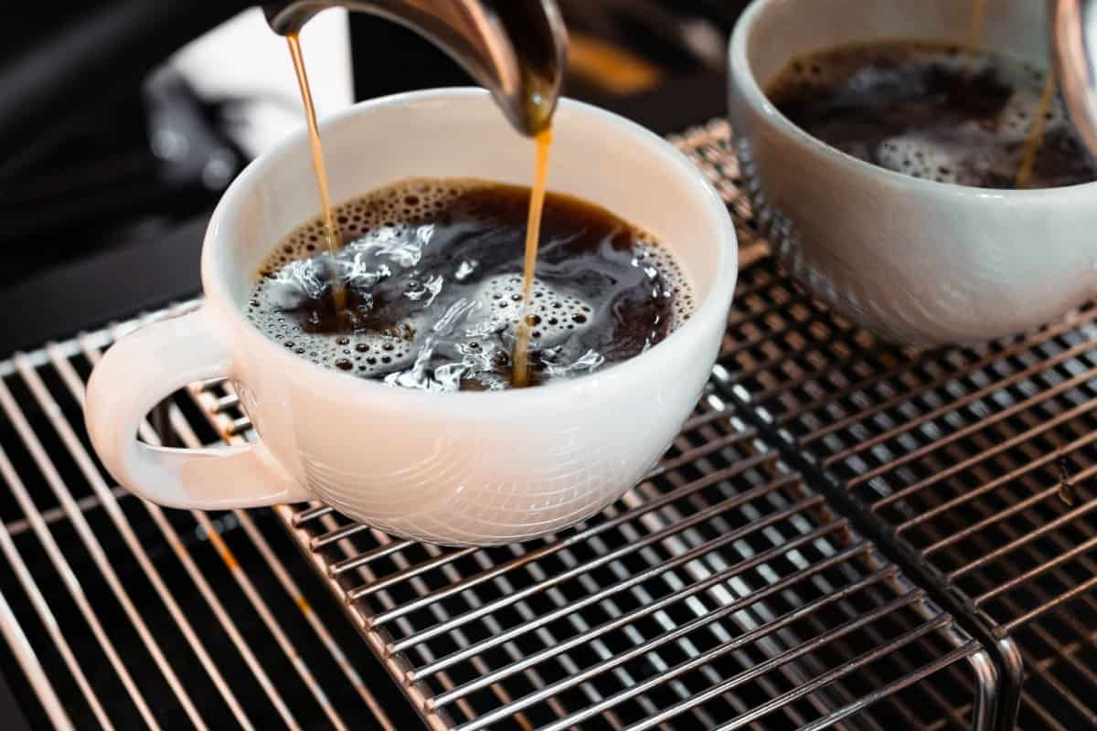 Tazas de café recién servidas de cafetera de especialidad.